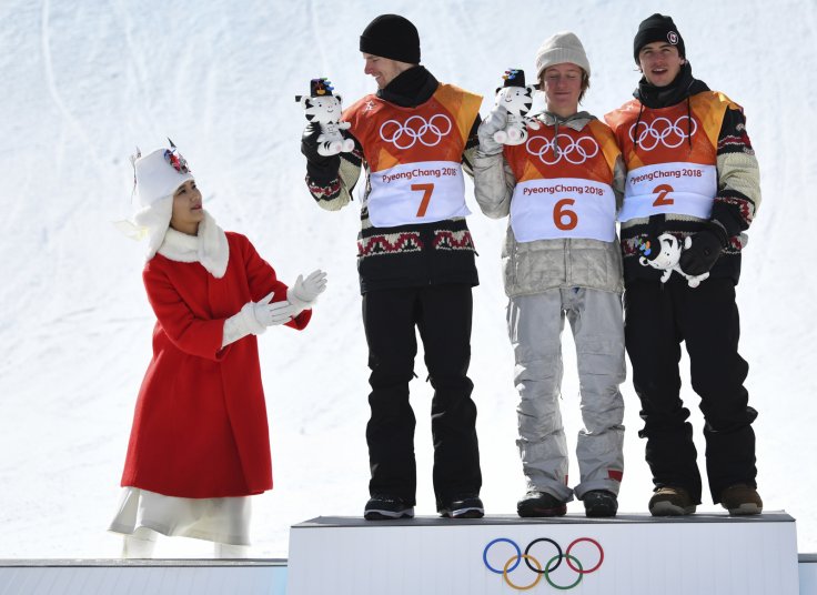 Men's Slopestyle Finals - Phoenix Snow Park - Pyeongchang, South Korea - February 11, 2018 - Gold medallist Redmond Gerard of the U.S., flanked by silver medallist Max Parrot of Canada and bronze medallist Mark McMorris of Canada, receive their game masco
