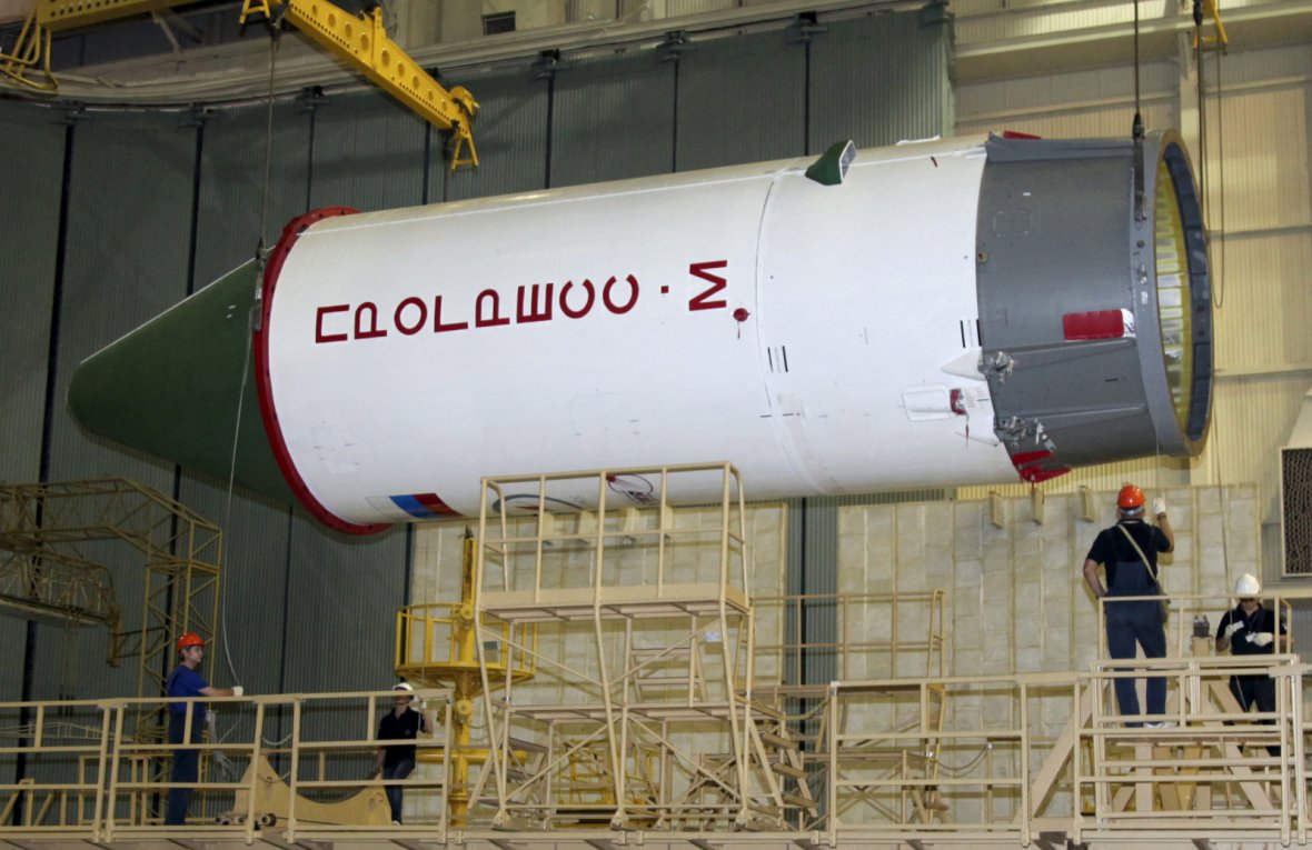 Employees work on a Russian Progress-M spacecraft during the preparations for the upcoming launch