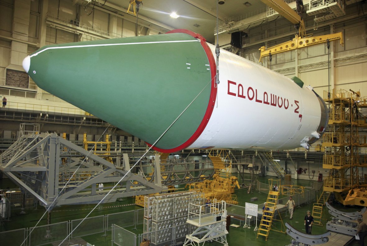 Employees work on a Russian Progress-M spacecraft during the preparations for the upcoming launch