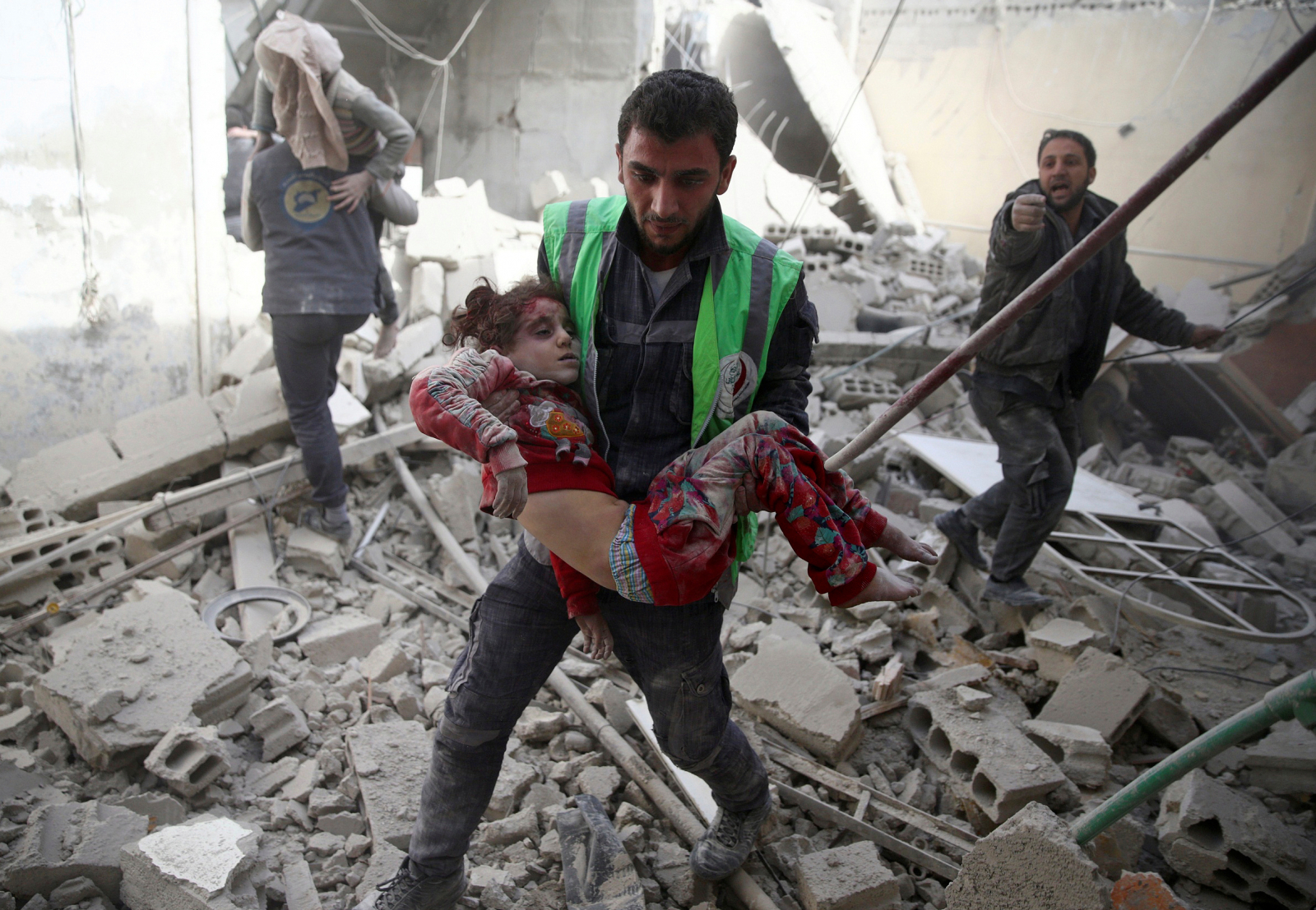 A civil defence member carries an injured girl after an airstrike in the rebel-held Douma neighbourhood of Damascus, Syria
