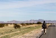 A migrant walks on a highway in the Mexican state of Sonora