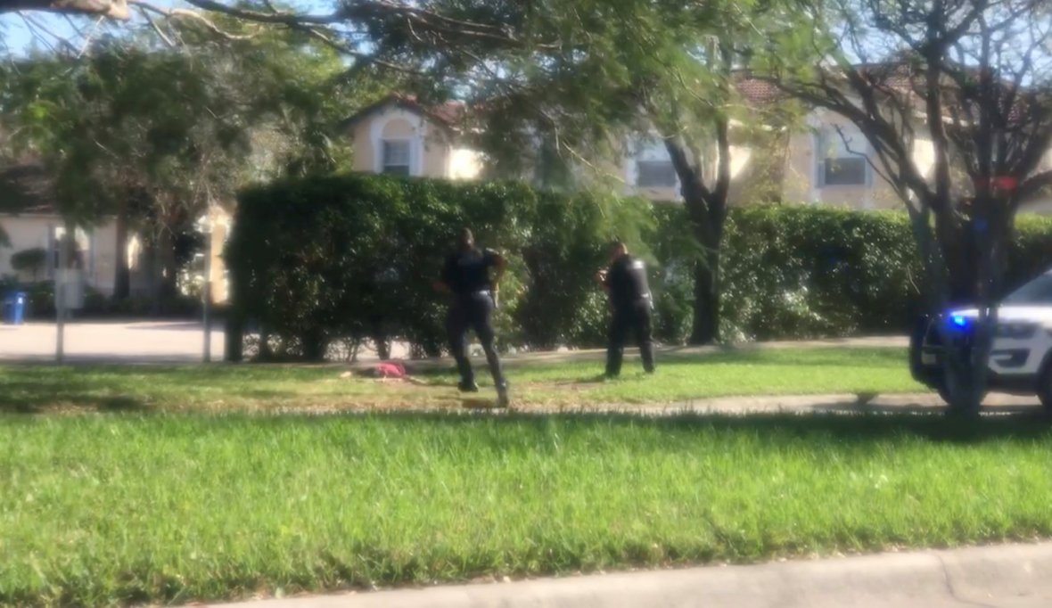 A man is approached by police officers, following a shooting incident in Parkland, Florida