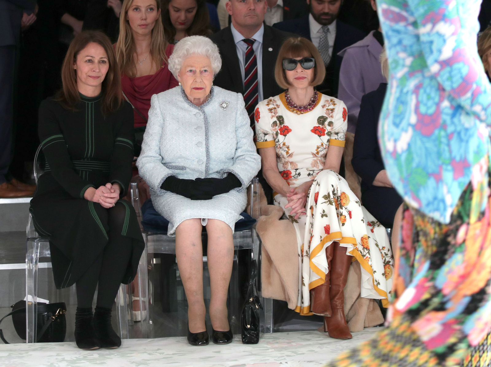 Britain's Queen Elizabeth II sits next to Vogue Editor-in-Chief Anna Wintour and Caroline Rush