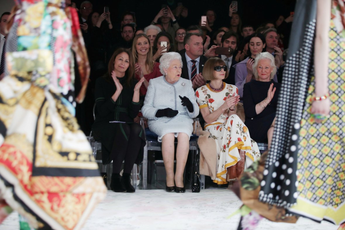 Britain's Queen Elizabeth II sits next to Vogue Editor-in-Chief Anna Wintour and Caroline Rush