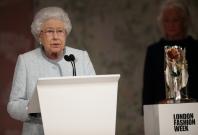 Britain's Queen Elizabeth II speaks before presenting Richard Quinn with the inaugural Queen Elizabeth II Award for British Design as she visits London Fashion Week
