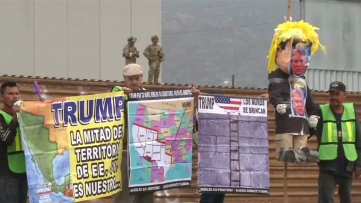 protesters-greet-president-trump-as-he-visits-border-wall-prototypes