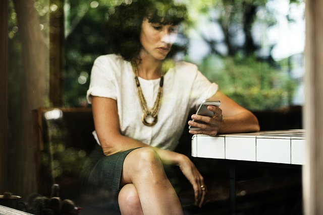 Woman sitting with phone 