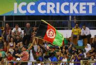An Afghanistan flag is waved by a supporter of their cricket team