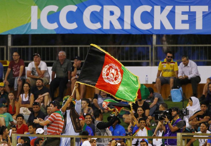 An Afghanistan flag is waved by a supporter of their cricket team