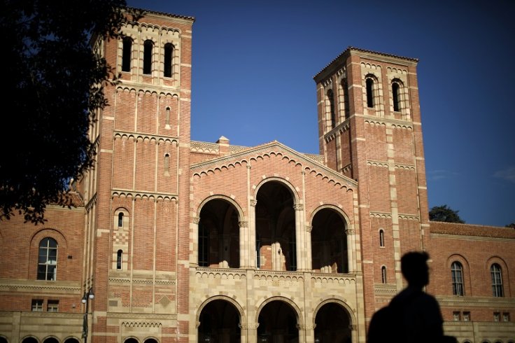 A student walks past Royce Hall on the University of California Los Angeles (UCLA) campus