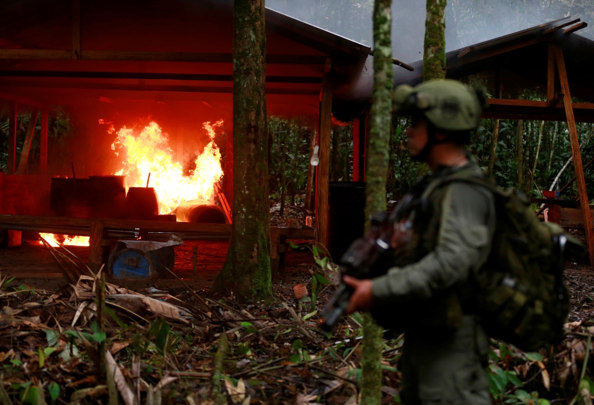 A Colombian anti-narcotics policeman stands guard after burning a cocaine lab in a rural area of Calamar in Guaviare state, Colombia.