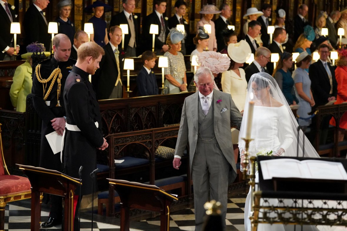 Prince Harry looks at his bride, Meghan Markle, as she arrives accompanied by the Prince of Wales in St George's Chapel at Windsor Castle for their wedding in Windsor, 