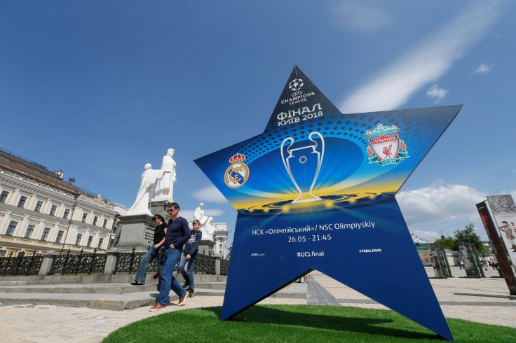 People walk pass an installation with the logo of the UEFA Champions League final in central Kiev, Ukraine 