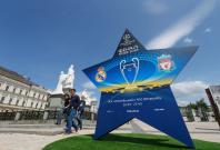 People walk pass an installation with the logo of the UEFA Champions League final in central Kiev, Ukraine People walk pass an installation with the logo of the UEFA Champions League final in central Kiev, Ukraine