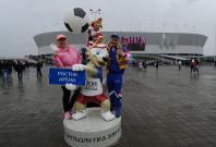 Russian Football Championship - FC Rostov vs FC Ural - Rostov Arena, Rostov-on-Don, Russia - May 13, 2018 Fans pose with the official mascot for the 2018 FIFA World Cup Zabivaka outside the stadium before the match. Russian Football Championship - FC Rostov vs FC Ural - Rostov Arena, Rostov-on-Don, Russia - May 13, 2018 Fans pose with the official mascot for the 2018 FIFA World Cup Zabivaka outside the stadium before the match.