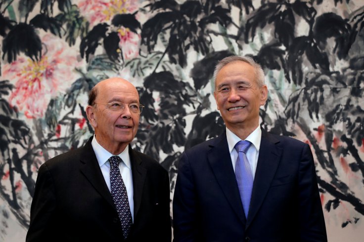 U.S. Commerce Secretary Wilbur Ross, left, chats with Chinese Vice Premier Liu He during a photograph session after their meeting at the Diaoyutai State Guesthouse in Beijing, China Sunday, Jun 3, 2018. 