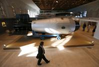A man walks past a shell, which is the replica of the biggest detonated Soviet nuclear bomb AN-602