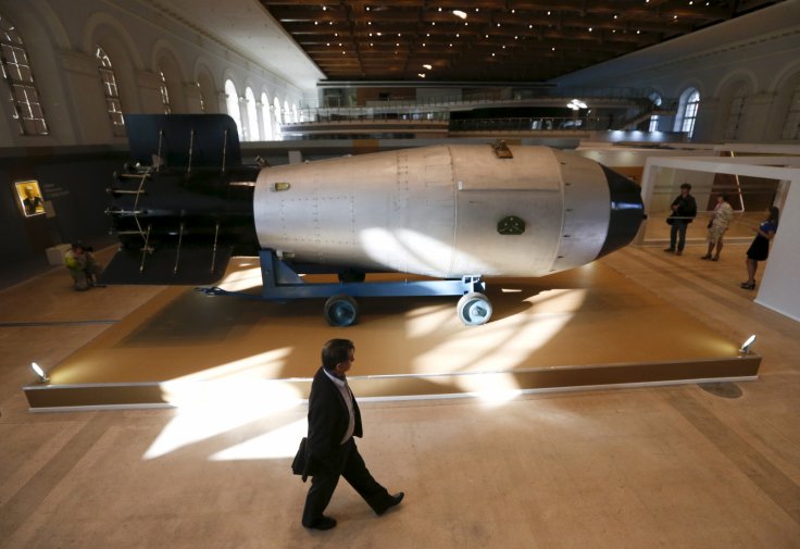 A man walks past a shell, which is the replica of the biggest detonated Soviet nuclear bomb AN-602