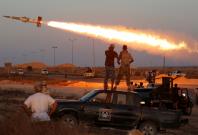 Fighters of Libyan forces allied with the UN backed government fire a rocket at Islamic State fighters in Sirte, Libya
