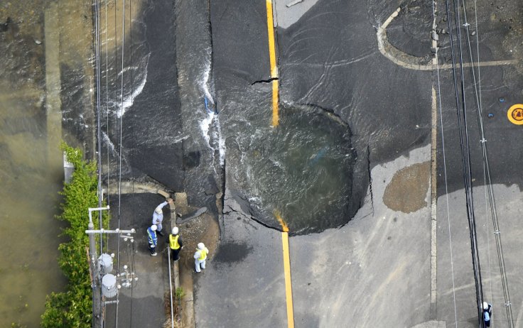Water flows out from cracks in a road damaged by an earthquake in Takatsuki, Osaka prefecture, western Japan, in this photo taken by Kyodo June 18, 2018. Water flows out from cracks in a road damaged by an earthquake in Takatsuki, Osaka prefecture, western Japan, in this photo taken by Kyodo June 18, 2018.