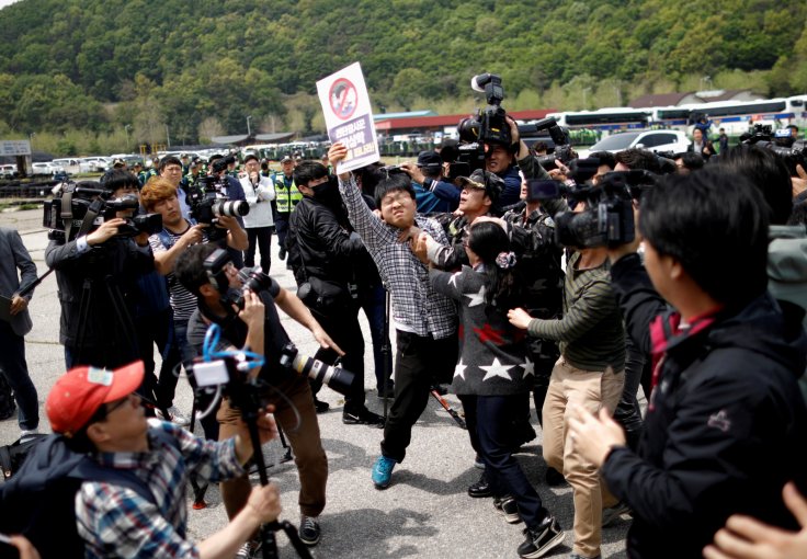 A North Korean defector tries to take an activist who opposes releasing balloons containing leaflets denouncing North Korean leader Kim Jong Un, away near the demilitarized zone in Paju, South Korea, May 5, 2018.