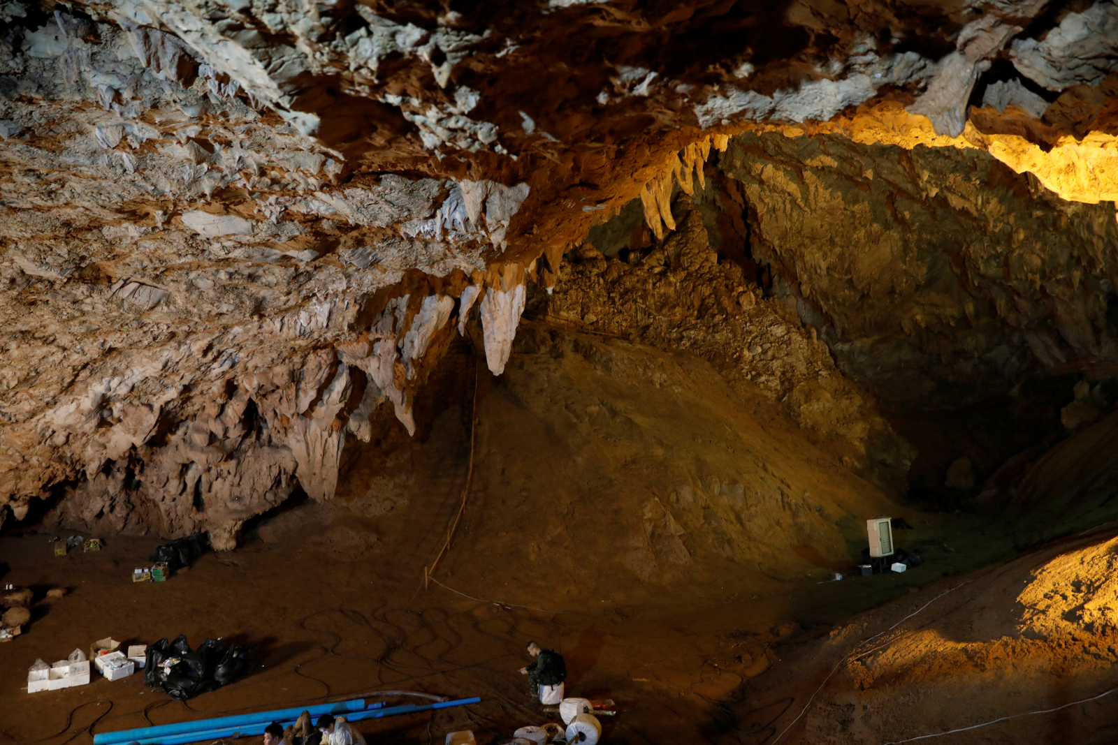 A soldier sits in the Tham Luang caves during a search for 12 members of an under-16 soccer team and their coach, in the northern province of Chiang Rai, Thailand, June 27, 