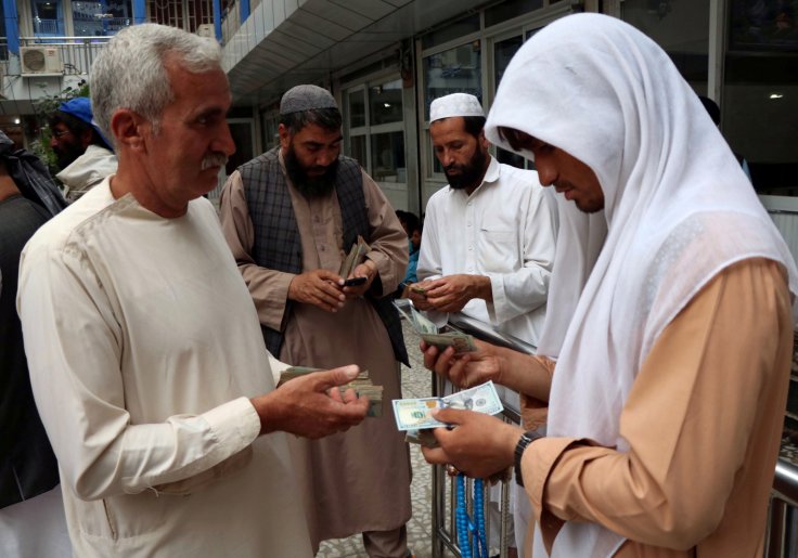 Afghan money changers gather to deal with foreign currency at a money change market in Herat province, Afghanistan June 3, 2018.