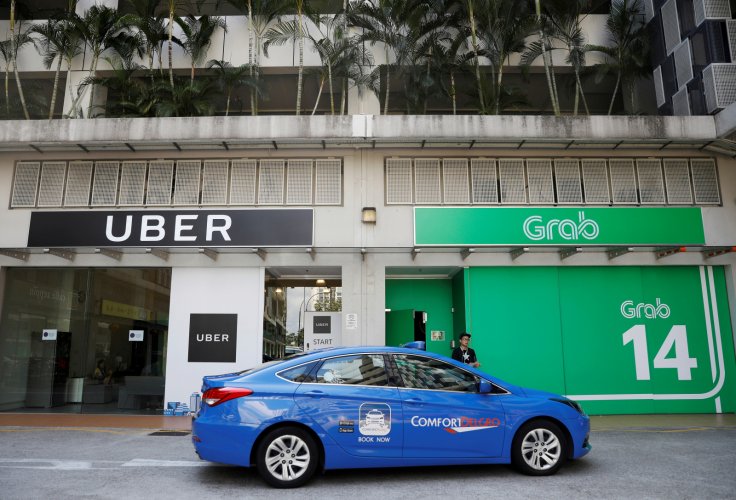 A ComfortDelgro taxi passes Uber and Grab offices in Singapore March 26, 2018.