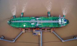 An oil tanker unloads crude oil at a crude oil terminal in Zhoushan, Zhejiang province, China July 4, 2018. Picture taken July 4, 2018. 