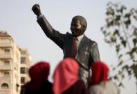 People look at the Mandela statue during the inauguration of Nelson Mandela Square in the West Bank city of Ramallah April 26, 2016. 