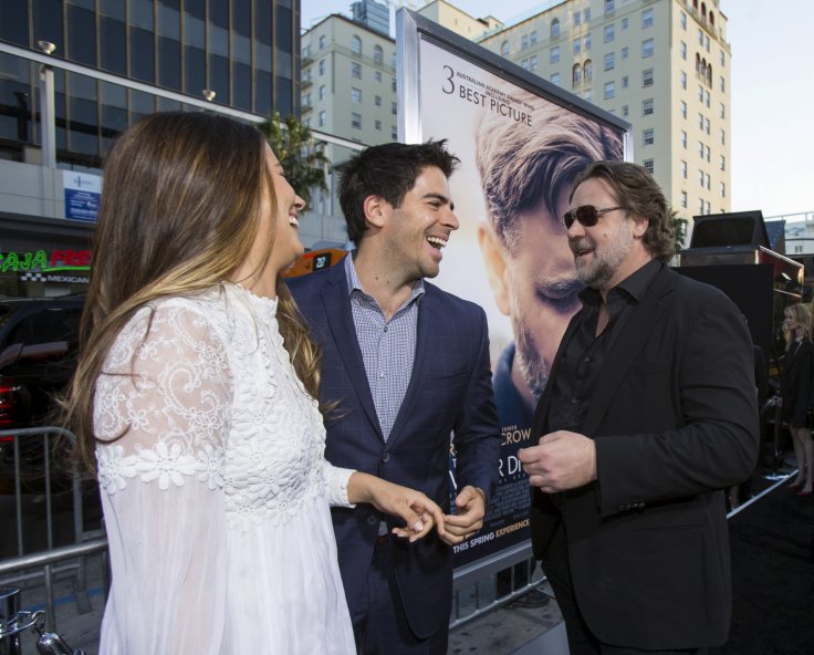 Director of the movie and cast member Russell Crowe (R) greets actor Eli Roth and his wife Lorenza Izzo at the premiere of "The Water Diviner" at the TCL Chinese theatre in Hollywood, California April 16, 2015. The movie opens limitedly in the U.S. on Apr
