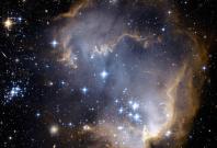Near the outskirts of the Small Magellanic Cloud, a satellite galaxy some 200 thousand light-years distant, lies the young star cluster NGC 602. Near the outskirts of the Small Magellanic Cloud, a satellite galaxy some 200 thousand light-years distant, lies the young star cluster NGC 602.