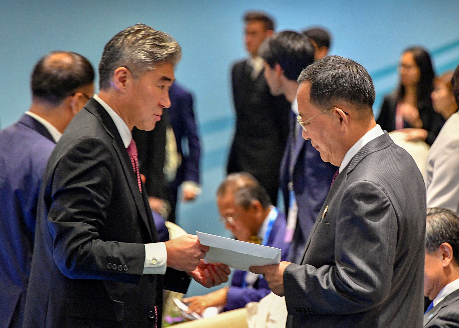 North Korea's Foreign Minister Ri Yong Ho is handed U.S. President Donald Trump's reply to North Korean leader Kim Jong Un's letter, by a member of the U.S. delegation at the ASEAN meeting in Singapore August 4, 2018.