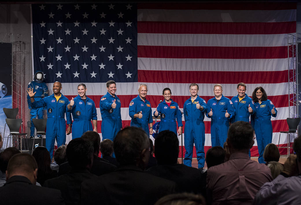 The first U.S. astronauts who will fly on American-made commercial spacecraft, to and from the International Space Station, wave after being announced, Friday, Aug. 3, 2018 at NASA's Johnson Space Center in Houston, Texas. The astronauts are, from left to