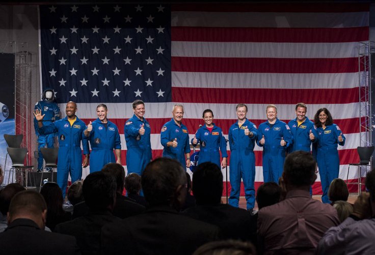 The first U.S. astronauts who will fly on American-made commercial spacecraft, to and from the International Space Station, wave after being announced, Friday, Aug. 3, 2018 at NASA's Johnson Space Center in Houston, Texas. The astronauts are, from left to