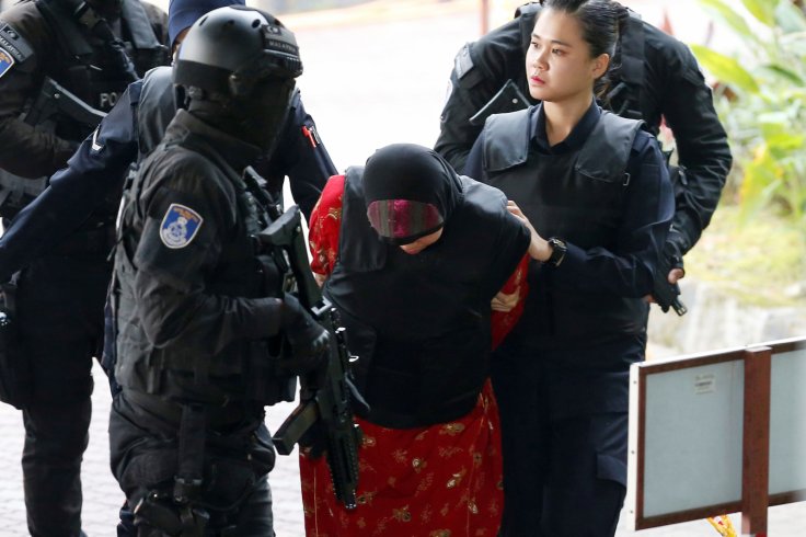 Indonesian Siti Aisyah, who is on trial for the killing of Kim Jong Nam, the estranged half-brother of North Korea's leader, is escorted as she arrives at the Shah Alam High Court on the outskirts of Kuala Lumpur, Malaysia August 16, 2018