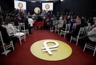 The Venezuelan cryptocurrency "Petro" logo is seen as Venezuela's President Nicolas Maduro speaks during a meeting with the ministers responsible for the economic sector at Miraflores Palace in Caracas, Venezuela March 22, 2018.