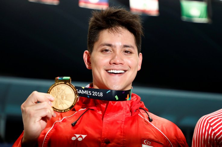 018 Asian Games - Men's 100m Butterfly Final - GBK Aquatics Center - Jakarta, Indonesia - August 22, 2018 Gold medalist Joseph Isaac Schooling of Singapore poses for a photo during the medal ceremony 