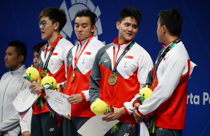 2018 Asian Games - Men's 4 x 100m Freestyle Relay Final - GBK Aquatic Center, Jakarta, Indonesia - August 22, 2018 Bronze medalists Darren Chua Yi Shou, Darren Lim Fang Yue, Joseph Schooling and Quah Zheng Wen of Singapore during the medal ceremony 