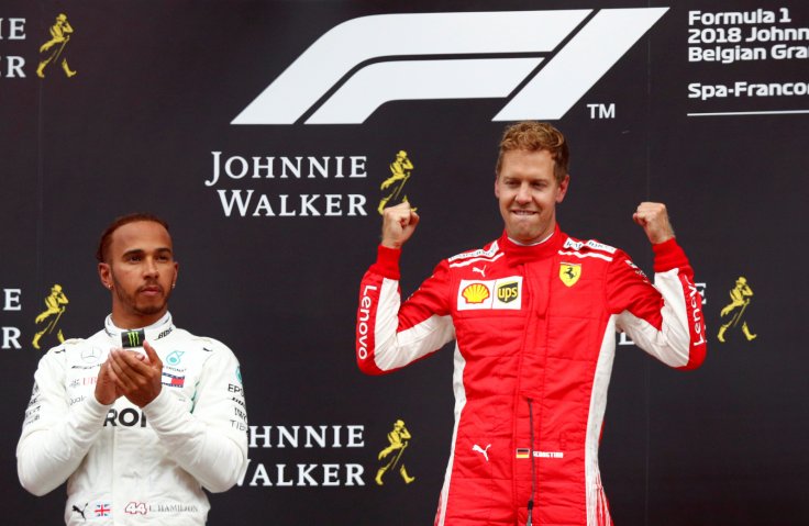 Spa-Francorchamps, Stavelot, Belgium - August 26, 2018 Ferrari's Sebastian Vettel celebrates on the podium after winning the race while Mercedes' Lewis Hamilton looks on