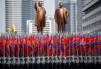 People carry flags in front of statues of North Korea founder Kim Il Sung (L) and late leader Kim Jong Il during a military parade marking the 105th birth anniversary Kim Il Sung, in Pyongyang April 15, 2017. REUTERS/Damir Sagolj/Files People carry flags in front of statues of North Korea founder Kim Il Sung (L) and late leader Kim Jong Il during a military parade marking the 105th birth anniversary Kim Il Sung, in Pyongyang April 15, 2017. REUTERS/Damir Sagolj/Files