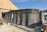 The world's largest concrete 3D printer constructs a 500-square-foot barracks hut at the U.S. Army Engineer Research and Development Center in mid-August in Champaign, Illinois. The world's largest concrete 3D printer constructs a 500-square-foot barracks hut at the U.S. Army Engineer Research and Development Center in mid-August in Champaign, Illinois.