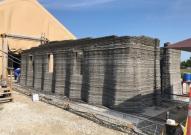 The world's largest concrete 3D printer constructs a 500-square-foot barracks hut at the U.S. Army Engineer Research and Development Center in mid-August in Champaign, Illinois.