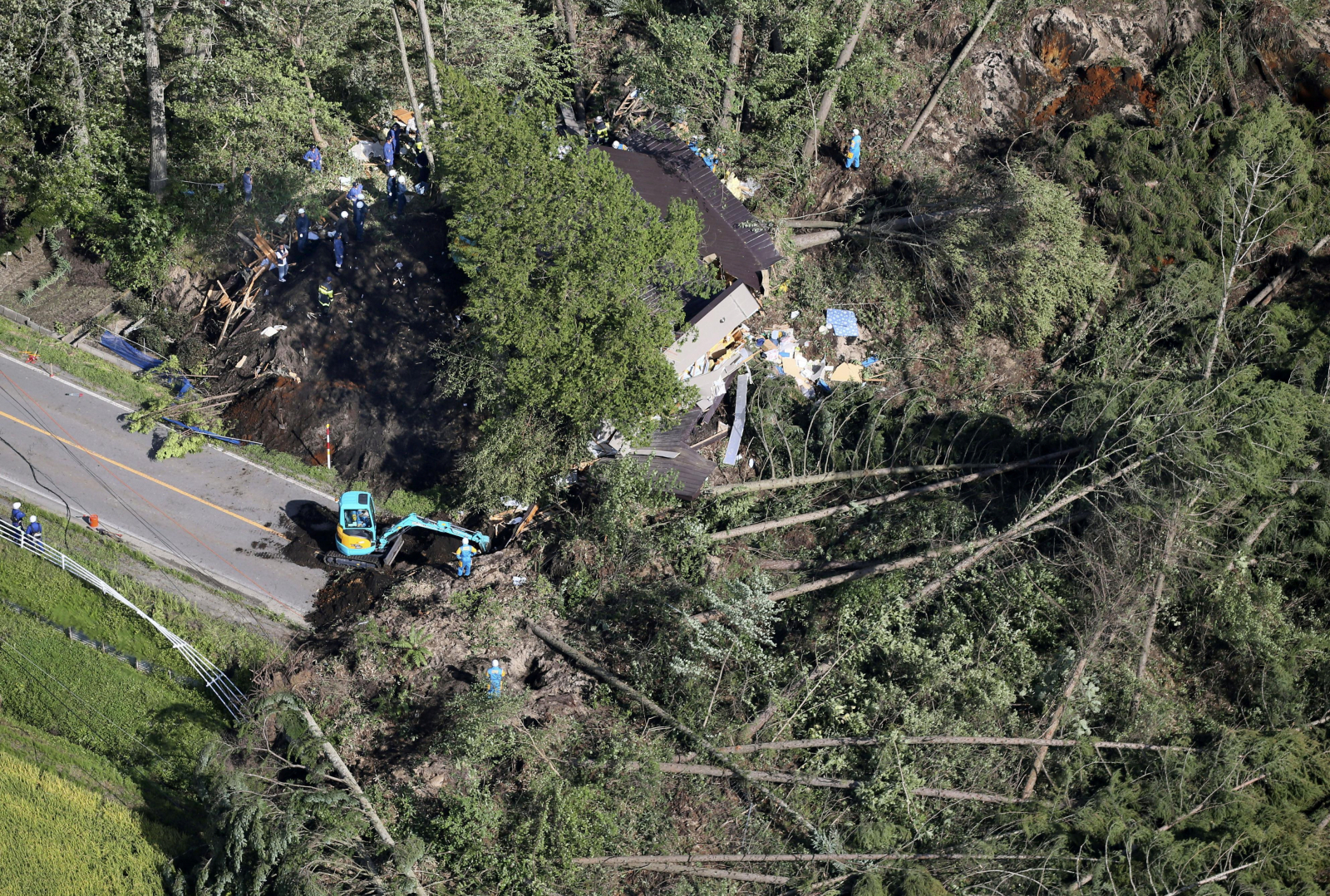 Police officers and rescue workers search for survivors from a building damaged by a landslide caused by a powerful earthquake in Atsuma town in Japan's northern island of Hokkaido, Japan, in this photo taken by Kyodo September 6, 2018. Mandatory credit K