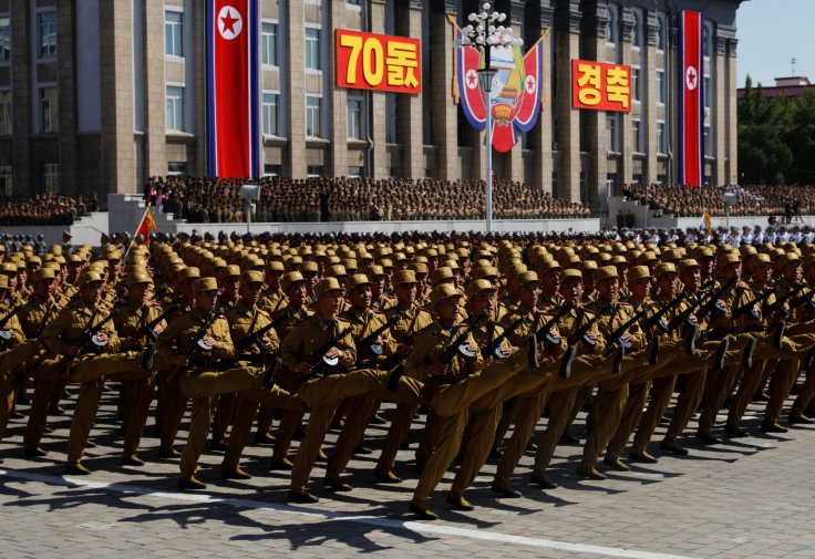 People wave plastic flowers and balloons during a military parade marking the 70th anniversary of North Korea's foundation in Pyongyang, North Korea, September 9, 2018.