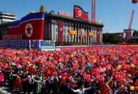 People wave plastic flowers and balloons during a military parade marking the 70th anniversary of North Korea's foundation in Pyongyang, North Korea, September 9, 2018. REUTERS/Danish Siddiqui People wave plastic flowers and balloons during a military parade marking the 70th anniversary of North Korea's foundation in Pyongyang, North Korea, September 9, 2018. REUTERS/Danish Siddiqui