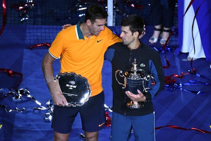 (L-R) Juan Martin Del Potro of Argentina and Novak Djokovic of Serbia poses with the runner-up and championship trophies (respectively) on day fourteen of the 2018 U.S. Open tennis tournament at USTA Billie Jean King National Tennis Center. Mandatory Cred