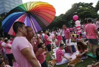Participants dressed in pink enjoy a picnic before taking part in the forming of a giant pink dot at the Speakers' Corner in Hong Lim Park in Singapore June 28, 2014. The annual Pink Dot Sg event promotes an acceptance of the Lesbian, Gay, Bisexual and Tr