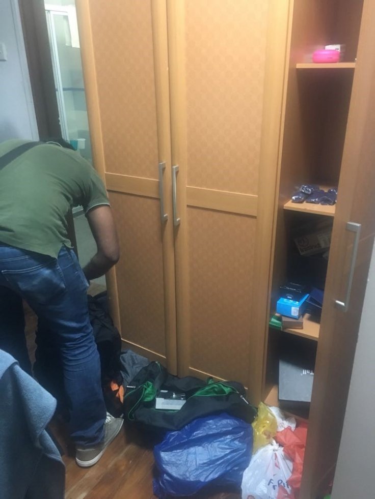 Photo (CNB): CNB officer conducting a search in a unit, in CNB island-wide operation from 10 to 14 September 2018.