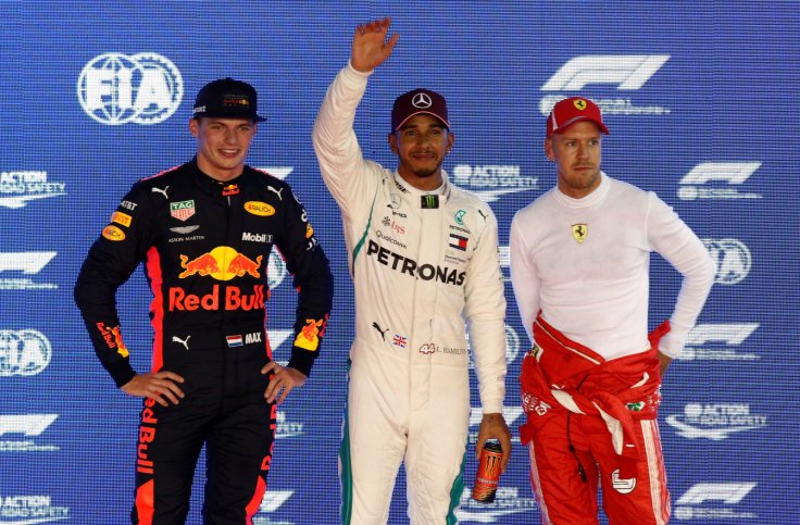 Formula One F1 - Singapore Grand Prix - Marina Bay Street Circuit, Singapore - September 15, 2018 Mercedes' Lewis Hamilton poses for a photograph on the podium after qualifying in pole position alongside second place Red Bull's Max Verstappen and third pl